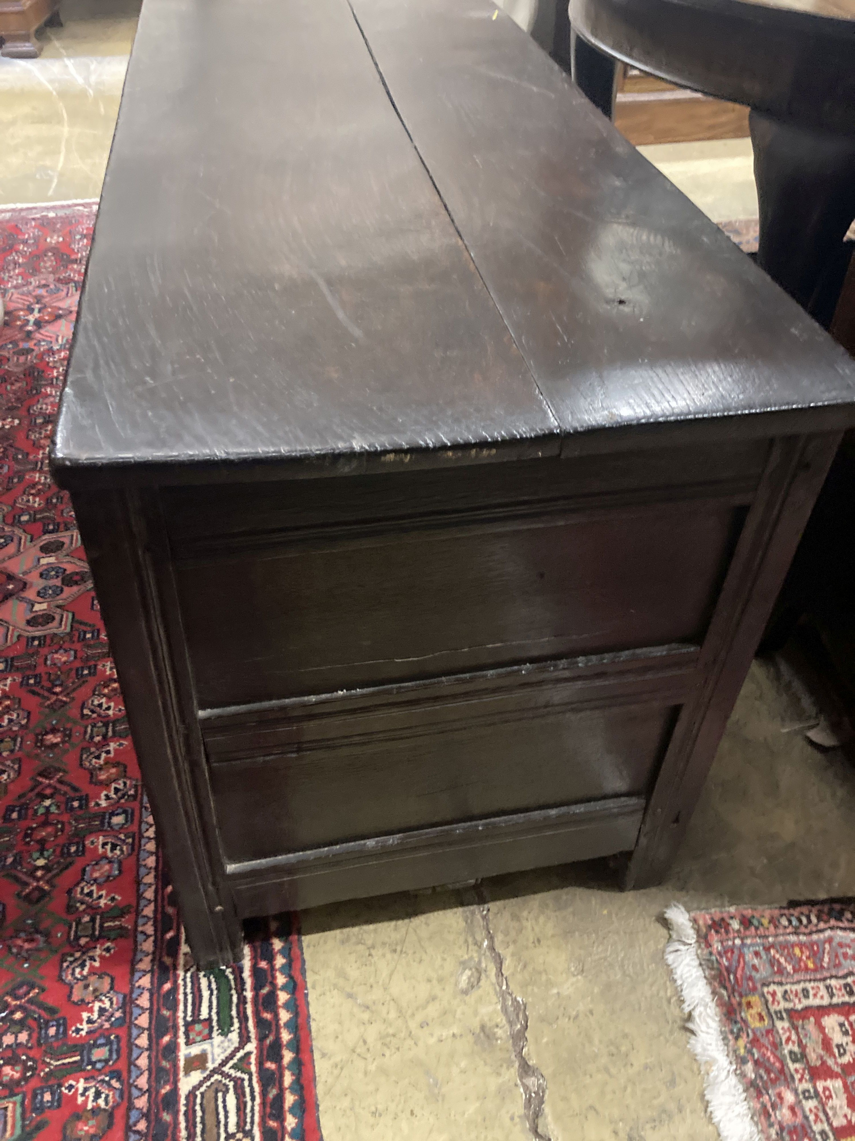 An 18th century panelled oak coffer, length 140cm, depth 54cm, height 67cm